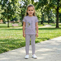 Close up of a child walking outdoors wearing Tinywing Tales hummingbird print leggings made of smooth, stretchy fabric for active play.