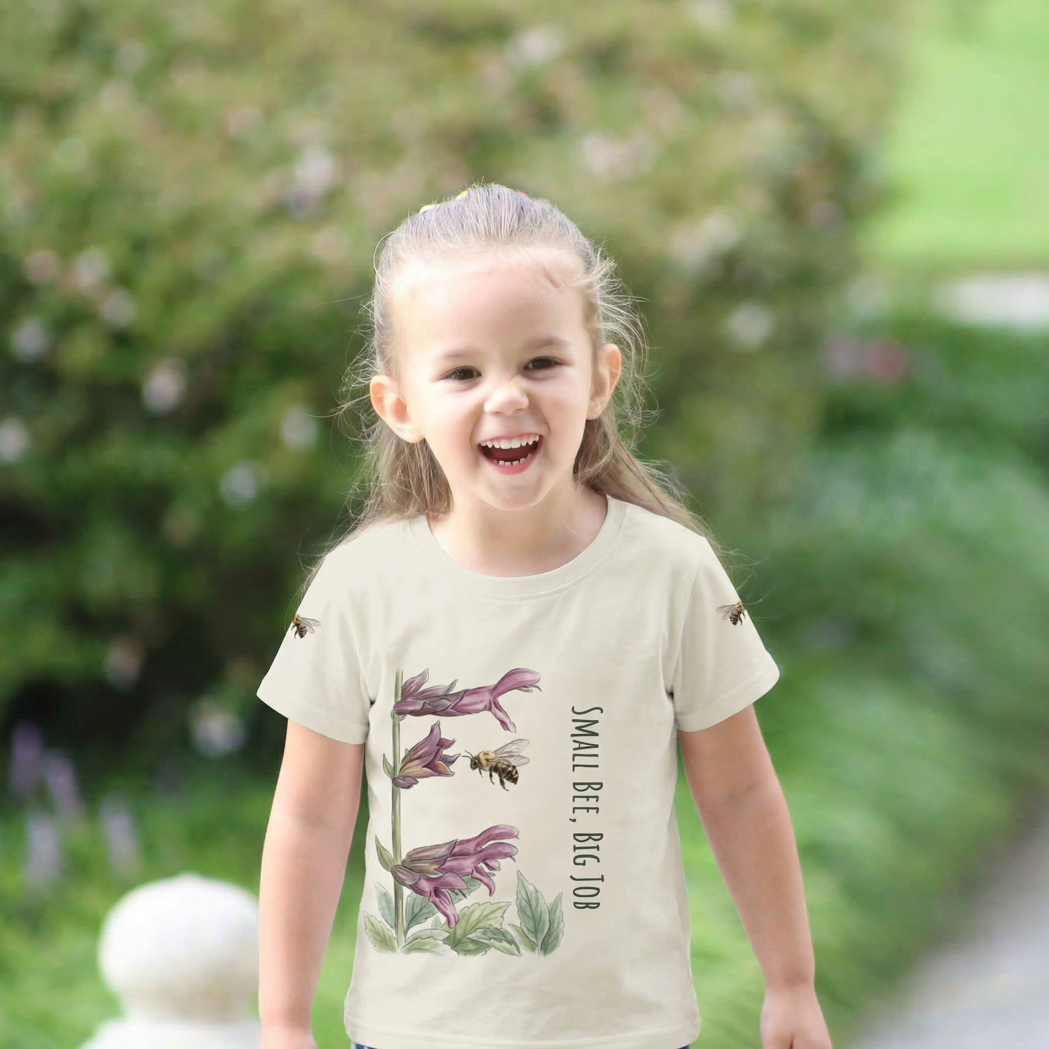 Toddler Girl  wearing cream Colored t-shirt with bee and flower design and text 'Small Bee, Big Job' Tinywing Tales Golden Dust Collection