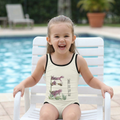 "Toddler girl wearing Meadow Whisper: Golden Dust kids Swimsuit sitting by a swimming pool."