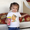 child wearing Toddler 100% cotton t-shirt in white featuring an all-over scattered pattern of bumblebees and wildflowers.