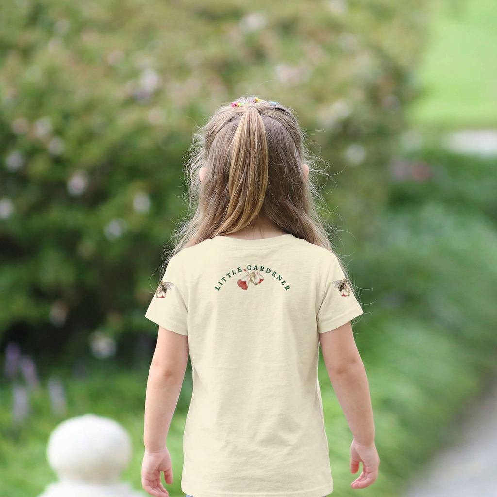 Back view ofChild wearing a 'LITTLE GARDENERS' t-shirt in a garden setting. Tinywing Tales