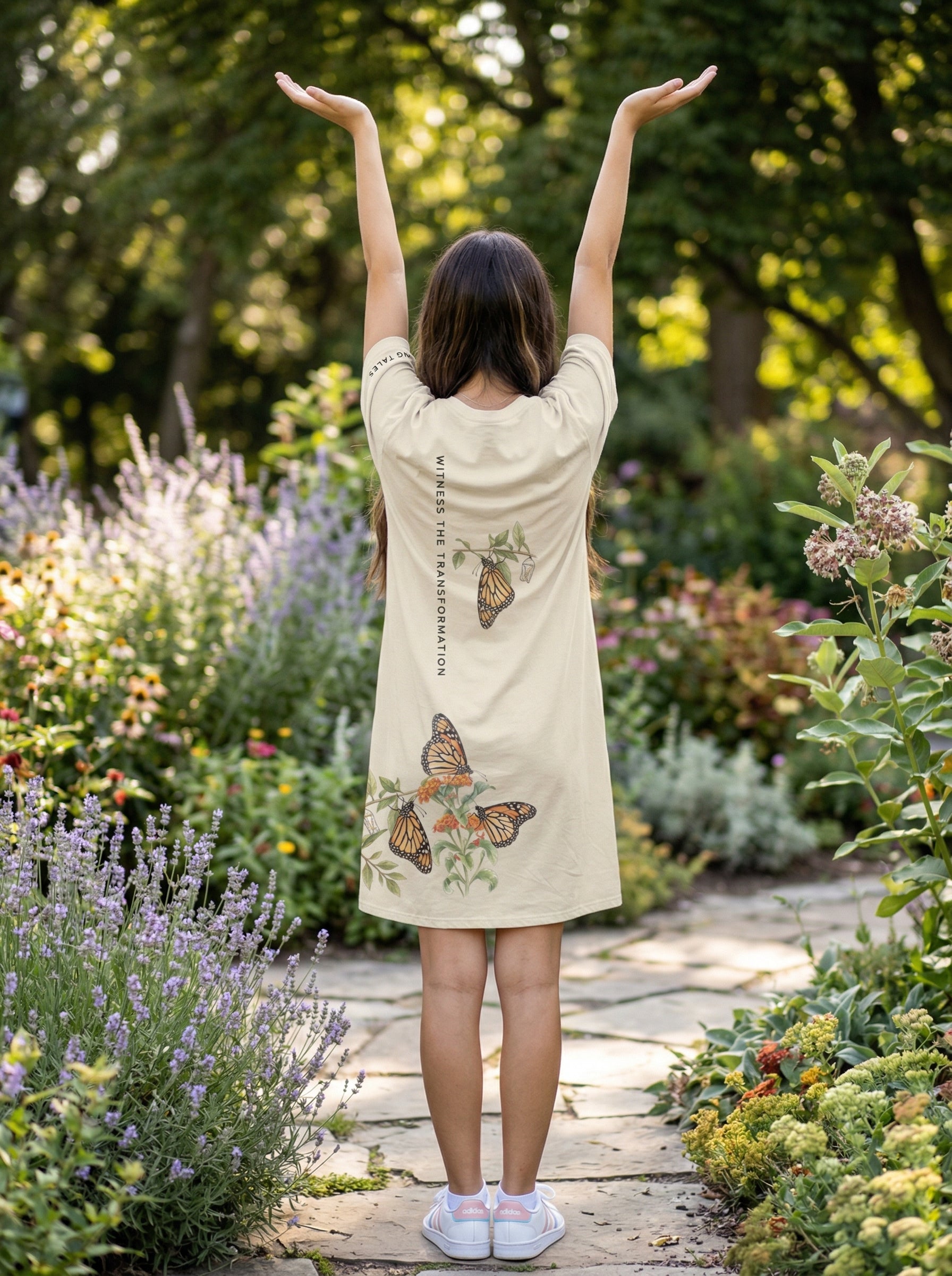 back view of young girl wearing tee shirt dress with butterfly graphic