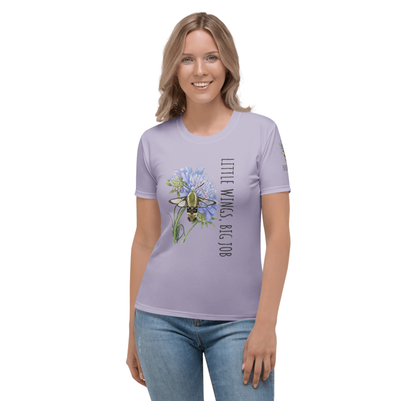 Woman wearing a lavender t-shirt with a graphic hummingbird moth and text "Little Wings, Big Job"