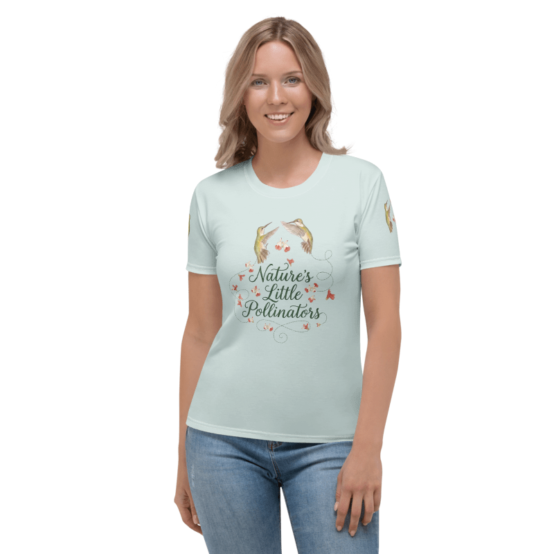 Woman wearing a light blue t-shirt with a graphic of hummingbirds and text "Nature's Little Pollinators"