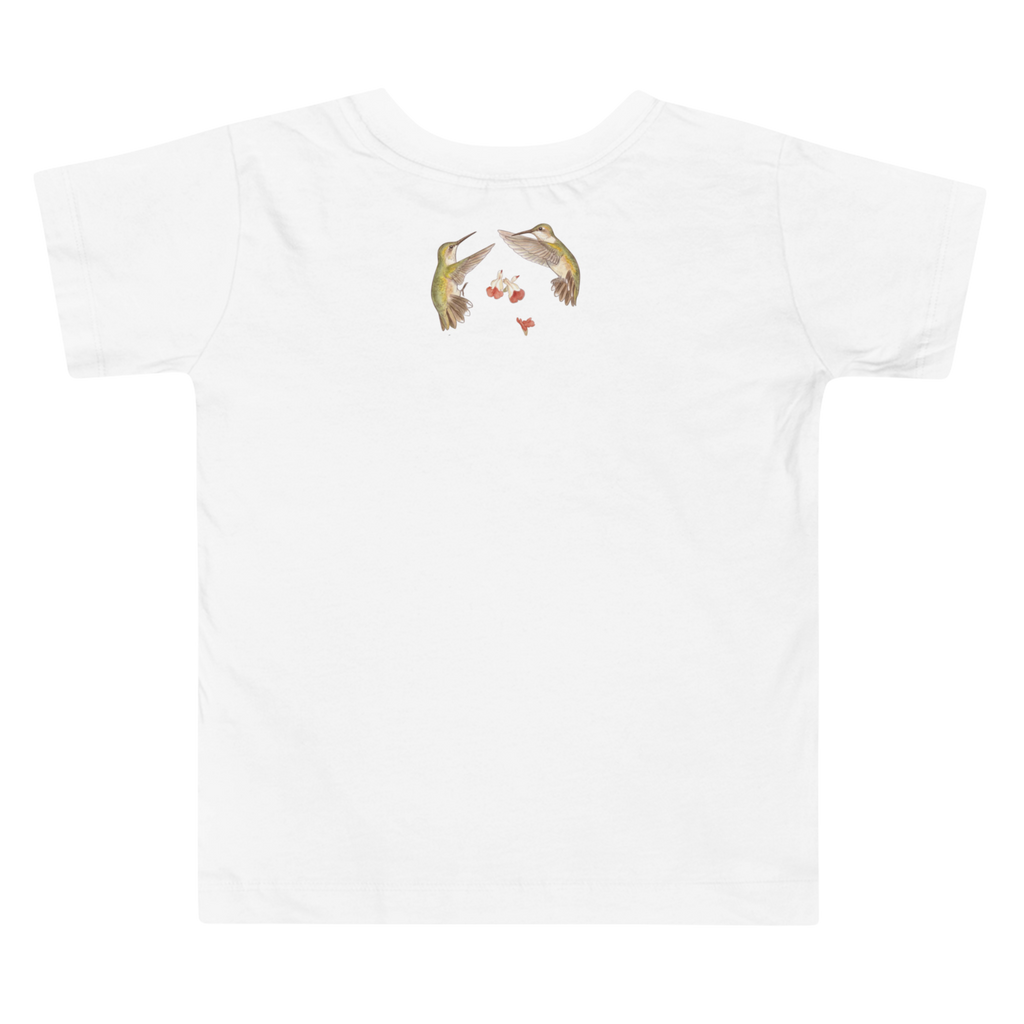 Back view of A white t-shirt with hummingbird graphics outdoors.