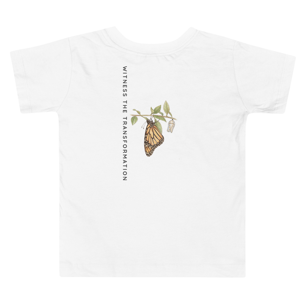 Back view of a White t-shirt with butterfly graphic and text 'Witness the Transformation' on a white background