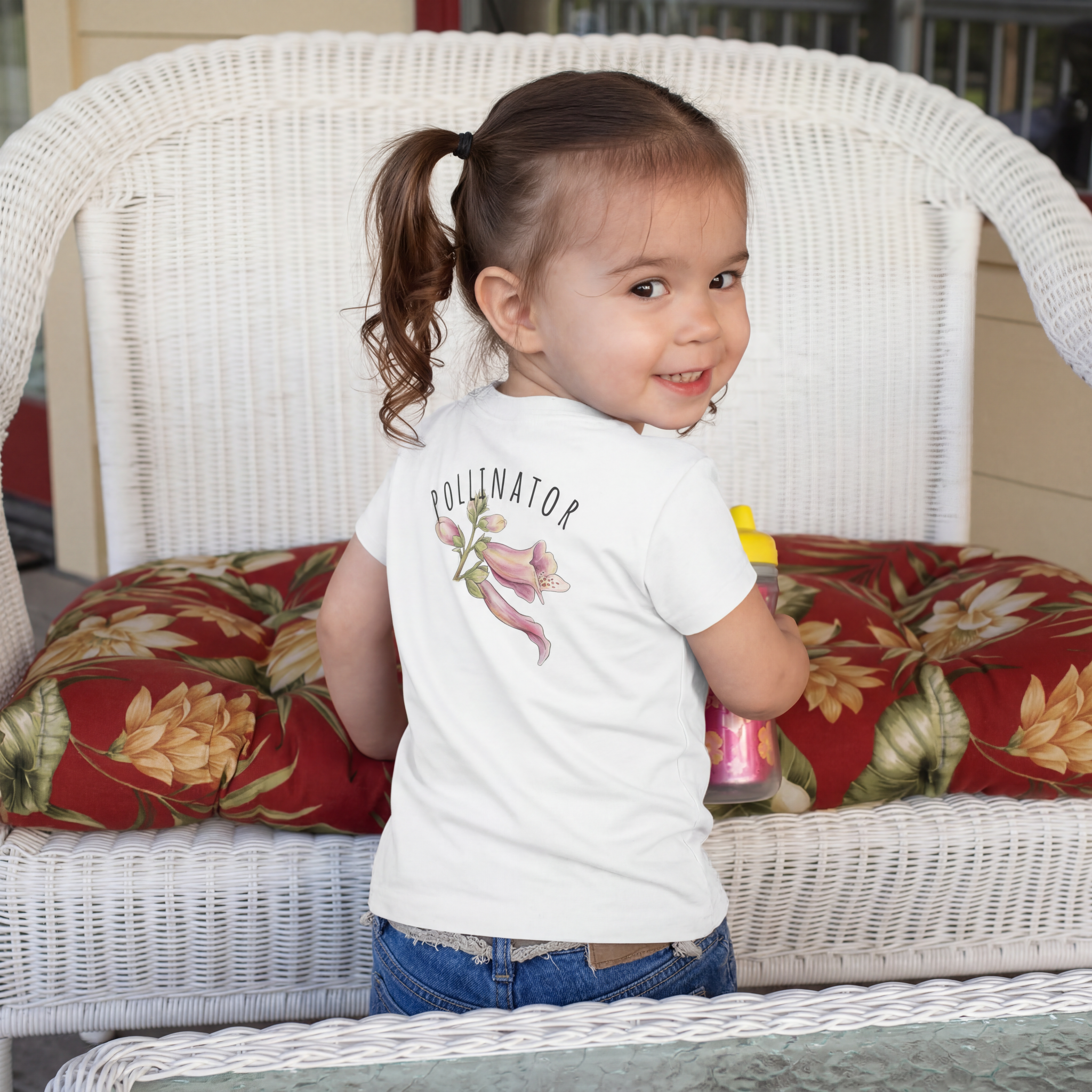 Back view of a child wearing White 100% cotton toddler t-shirt with 'Small Bee, Big Job' bee and foxglove illustration  on the front.