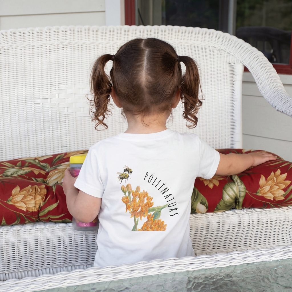 Back View of a child wearing Toddler 100% cotton t-shirt in white featuring an all-over scattered pattern of bumblebees and wildflowers.