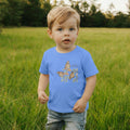 Child wearing a blue t-shirt with butterfly design in a grassy field