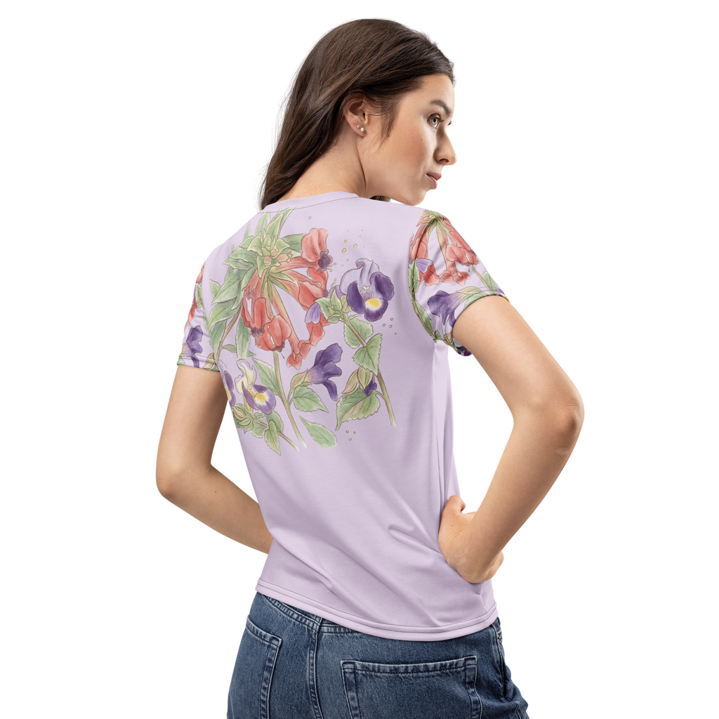 Woman wearing a light purple t-shirt with floral designs on a lavender background