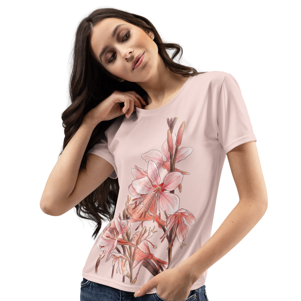 Woman wearing a light peach t-shirt with floral design 