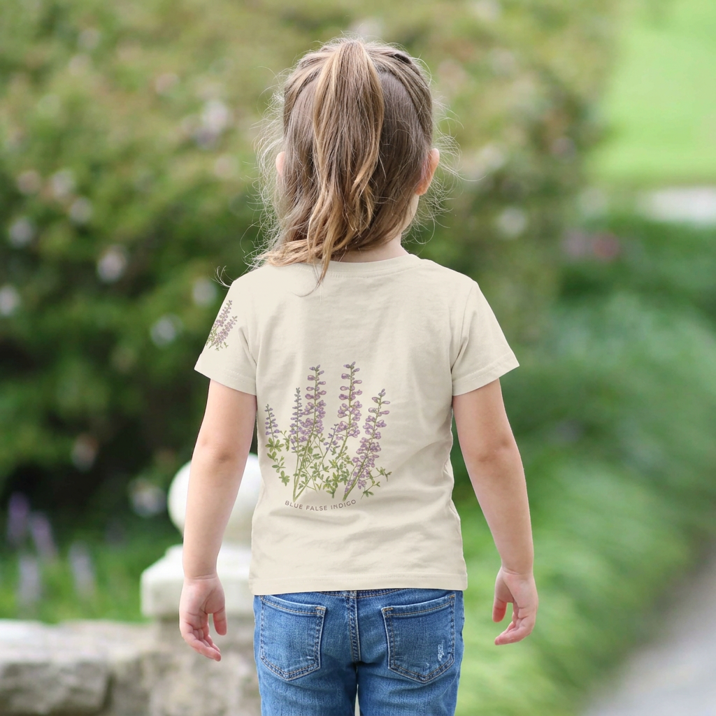 Backview of a Child wearing a beige t-shirt with floral design outdoors. Tinywing Tales