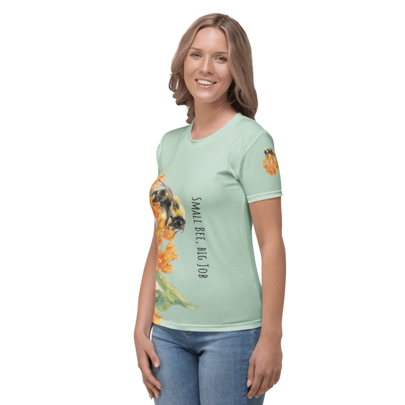 Left view of a Woman wearing a light green t-shirt with a bee and flower design