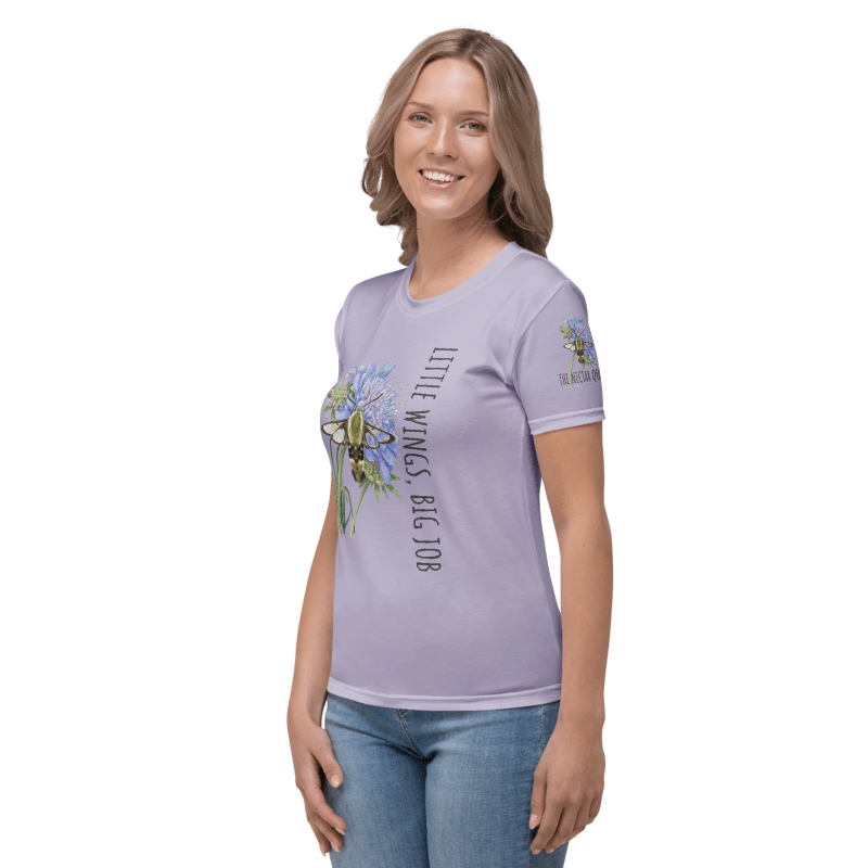 Left view of Woman wearing a lavender t-shirt with a graphic hummingbird moth and text "Little Wings, Big Job" same hummingbird moth graphic on her sleeve.