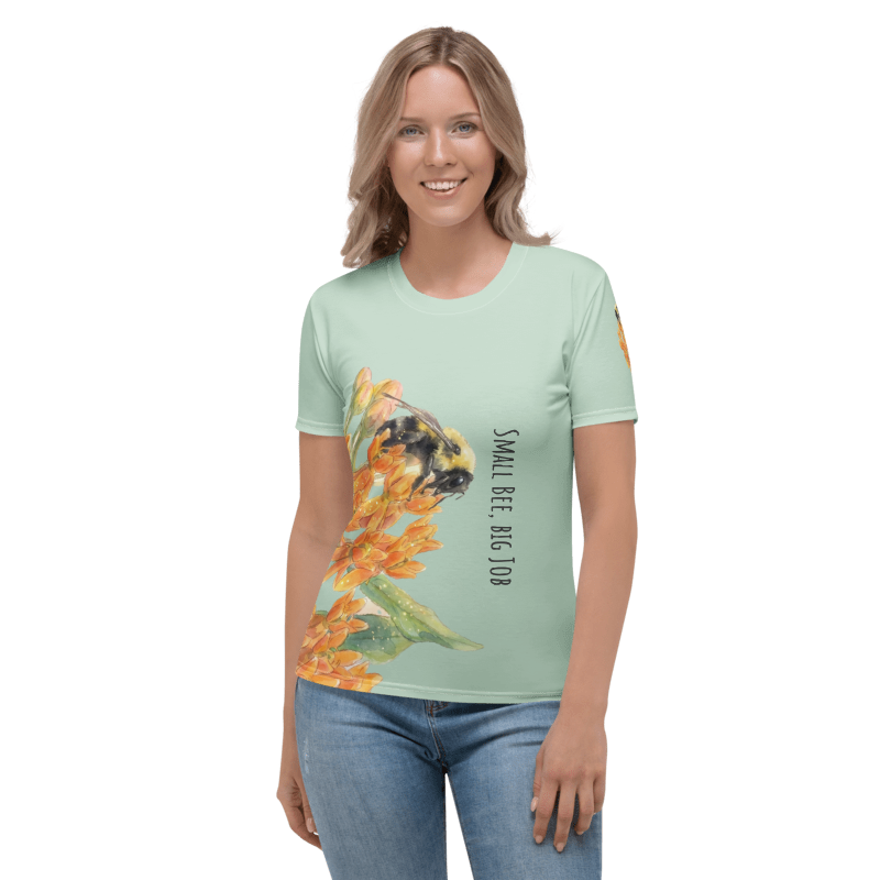 Woman wearing a light green t-shirt with a bee and flower design 