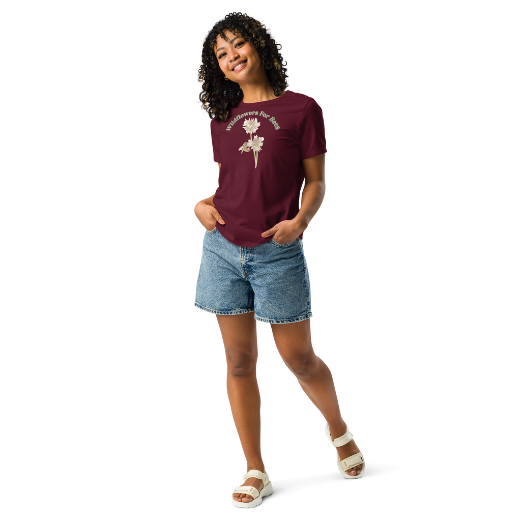 Woman wearing a maroon T-shirt with floral and bee design and text, "wildflowers for bees