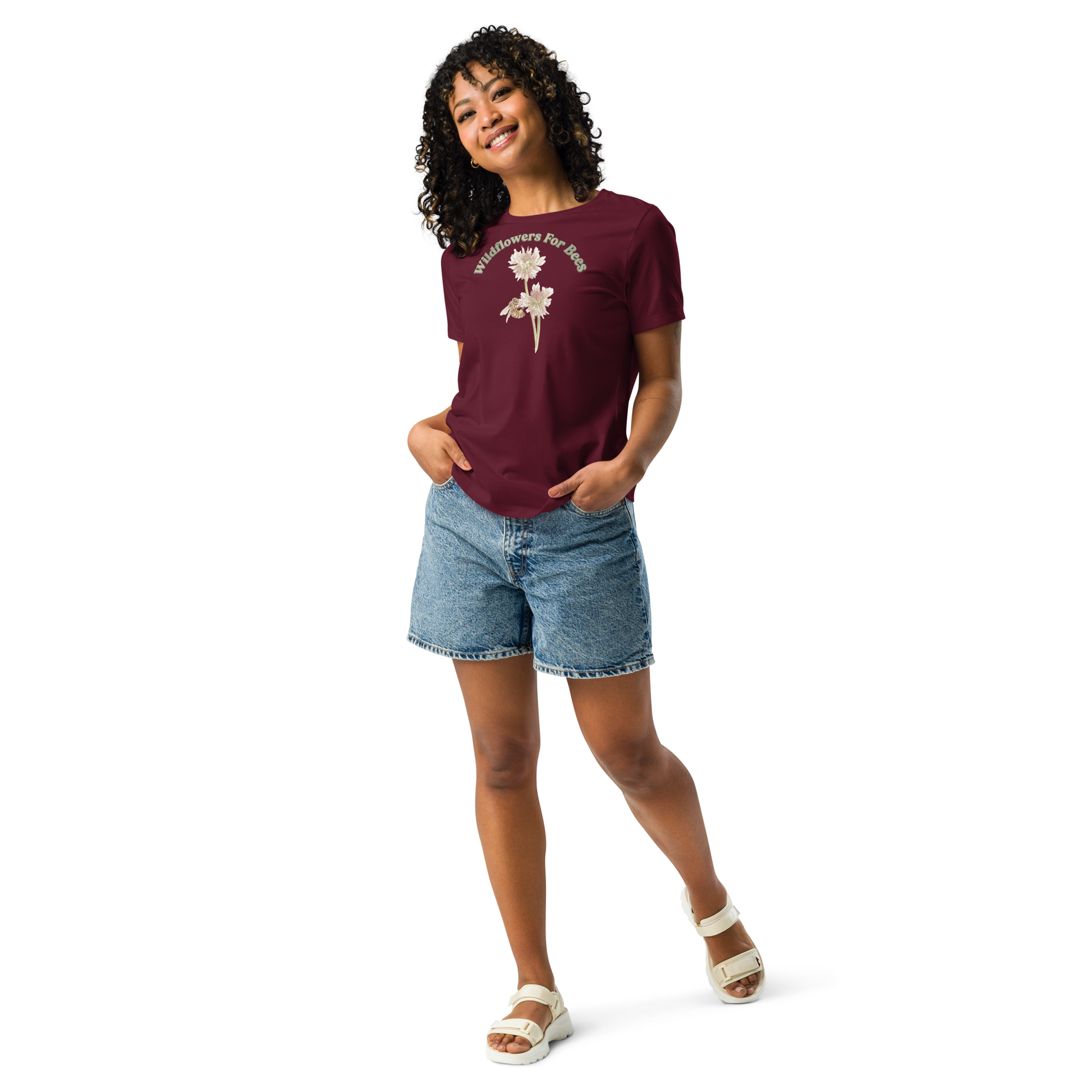 Woman wearing a maroon T-shirt with floral and bee design and text, "wildflowers for bees