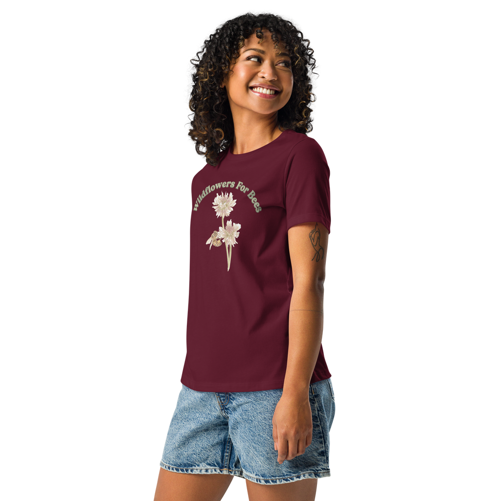 Woman wearing a maroon T-shirt with floral and bee design and text, "wildflowers for bees