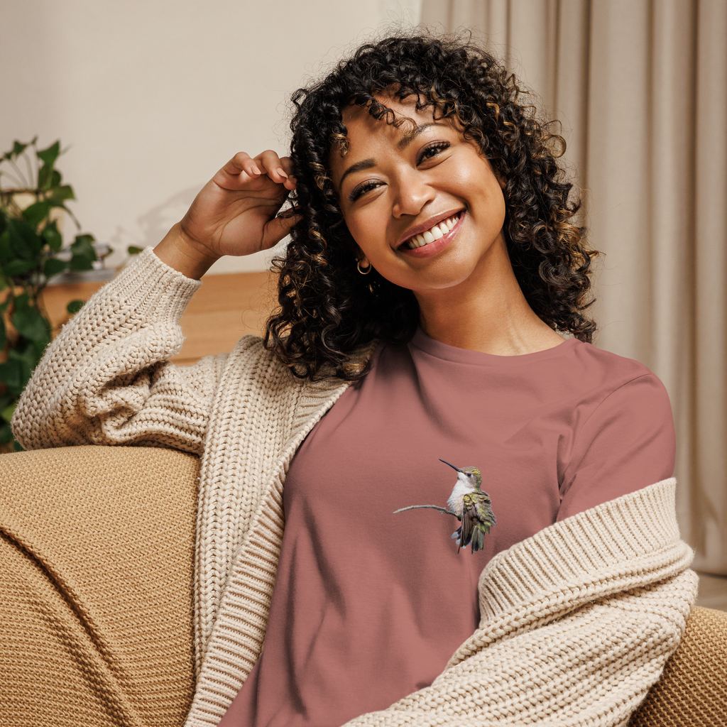 Woman wearing mauve tee shirt with photo of a hummingbird on a branch