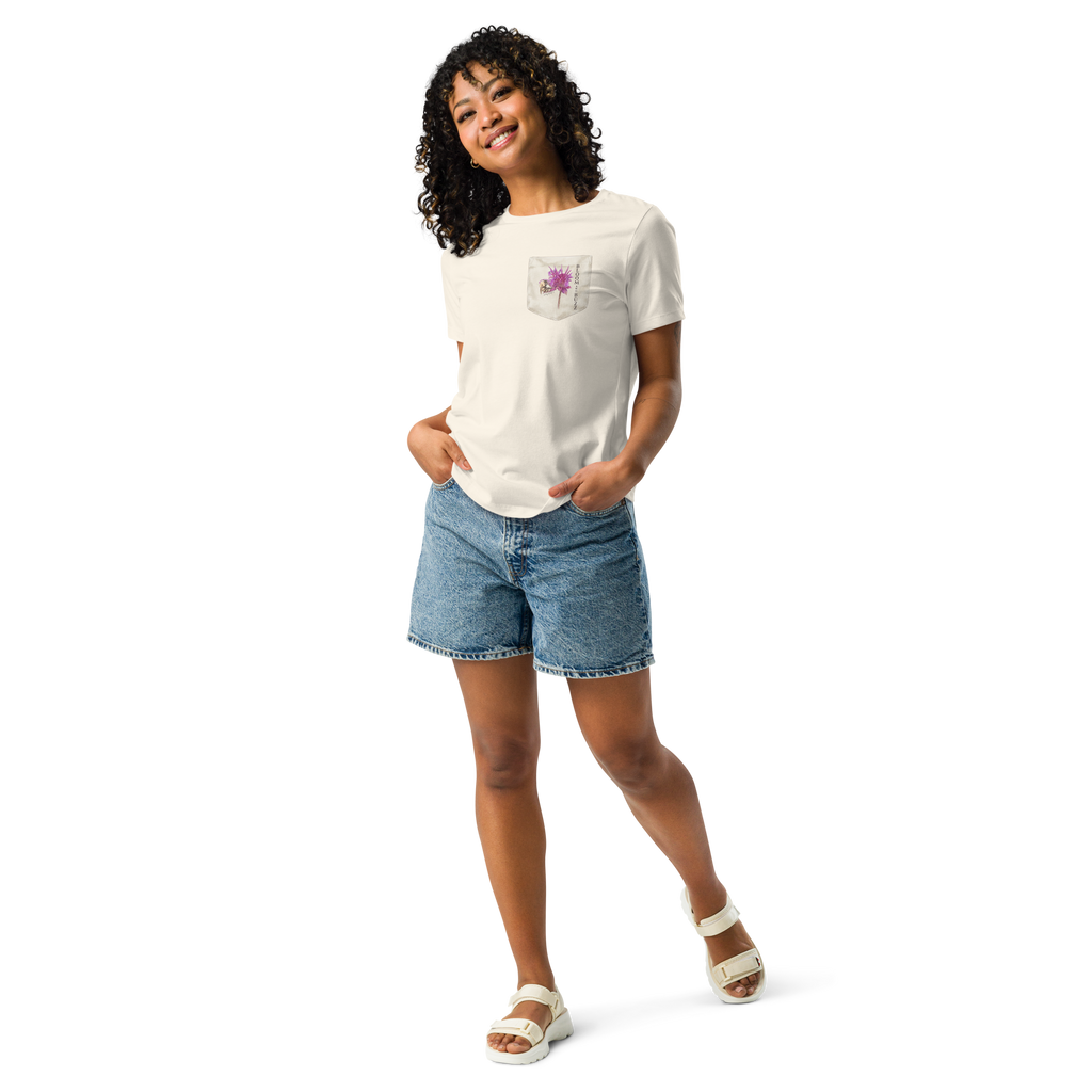 Woman wearing a beige t-shirt with bee and flower and text,  "BLOOM AND BUZZ"