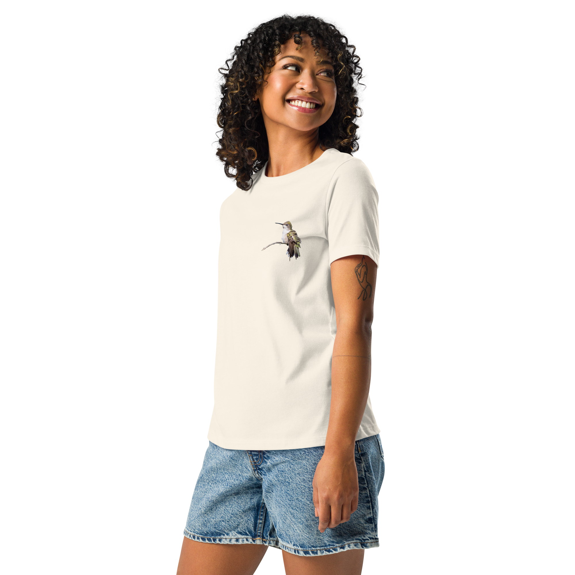 Left view of Woman wearing natural color tee shirt with photo of a hummingbird on a branch